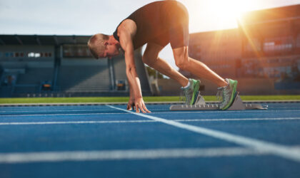 Young man on starting position about to run